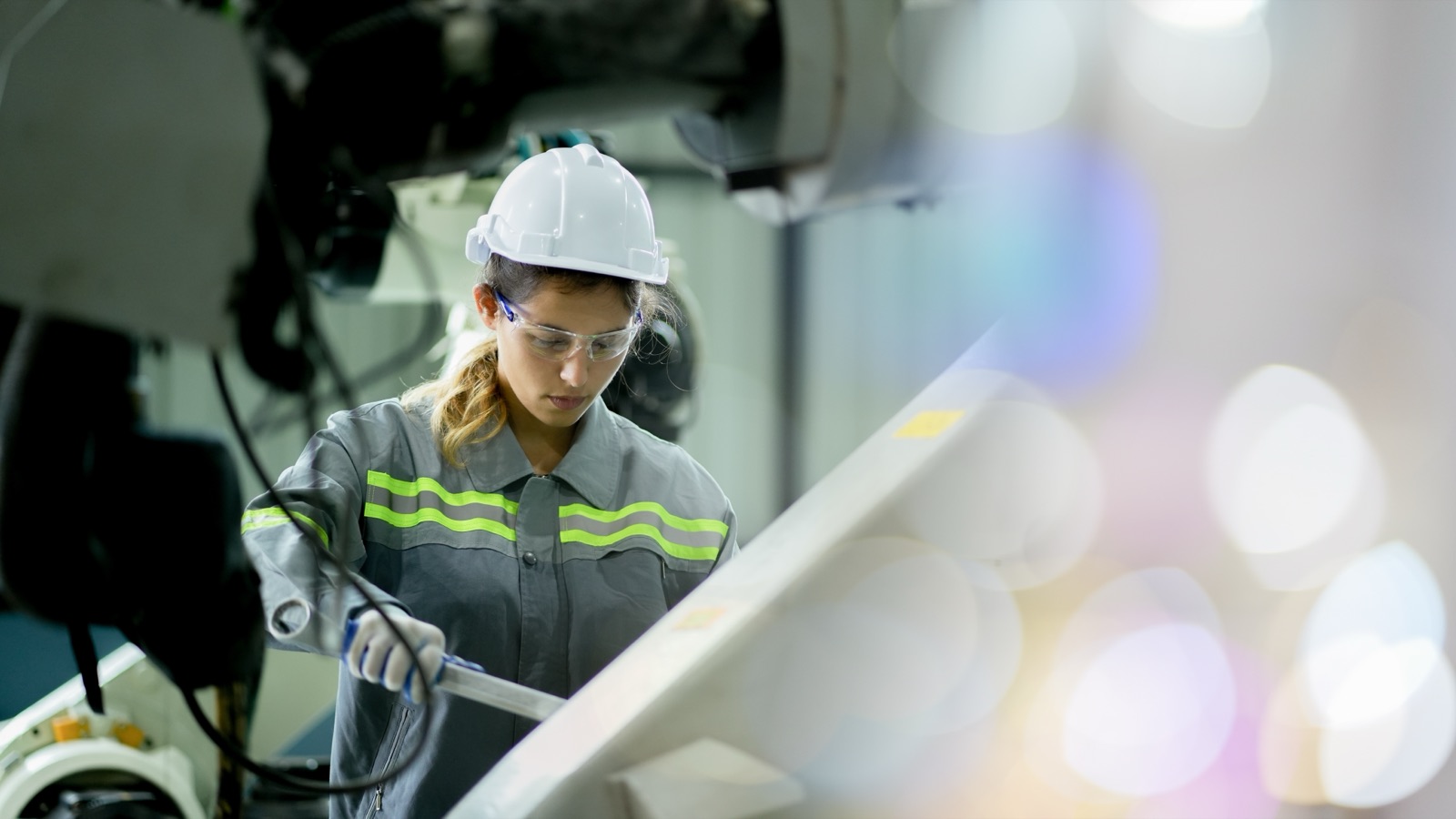 Operator inspecting parts at an assembly station