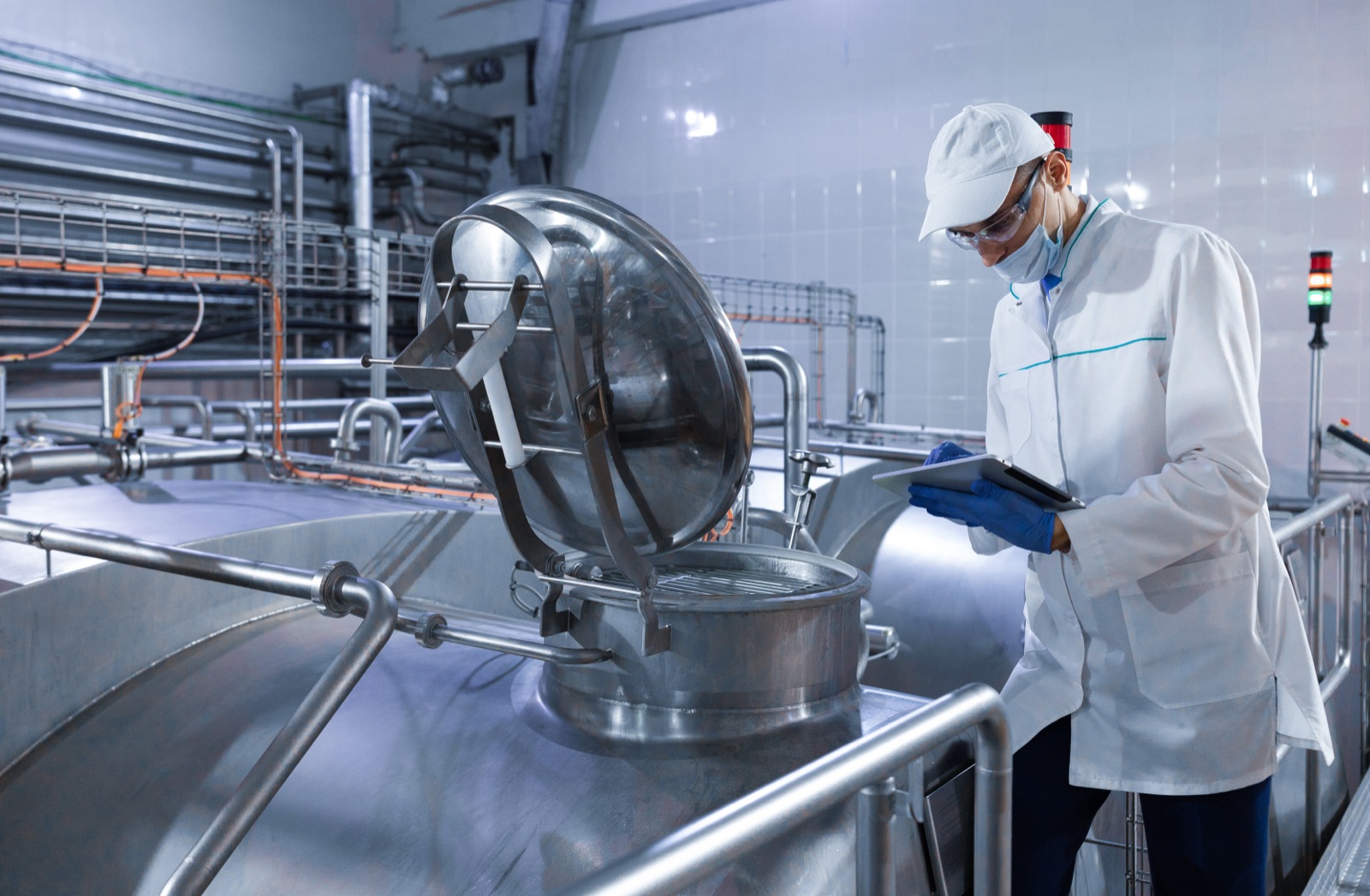 Technician checking a mixing tank on a tablet