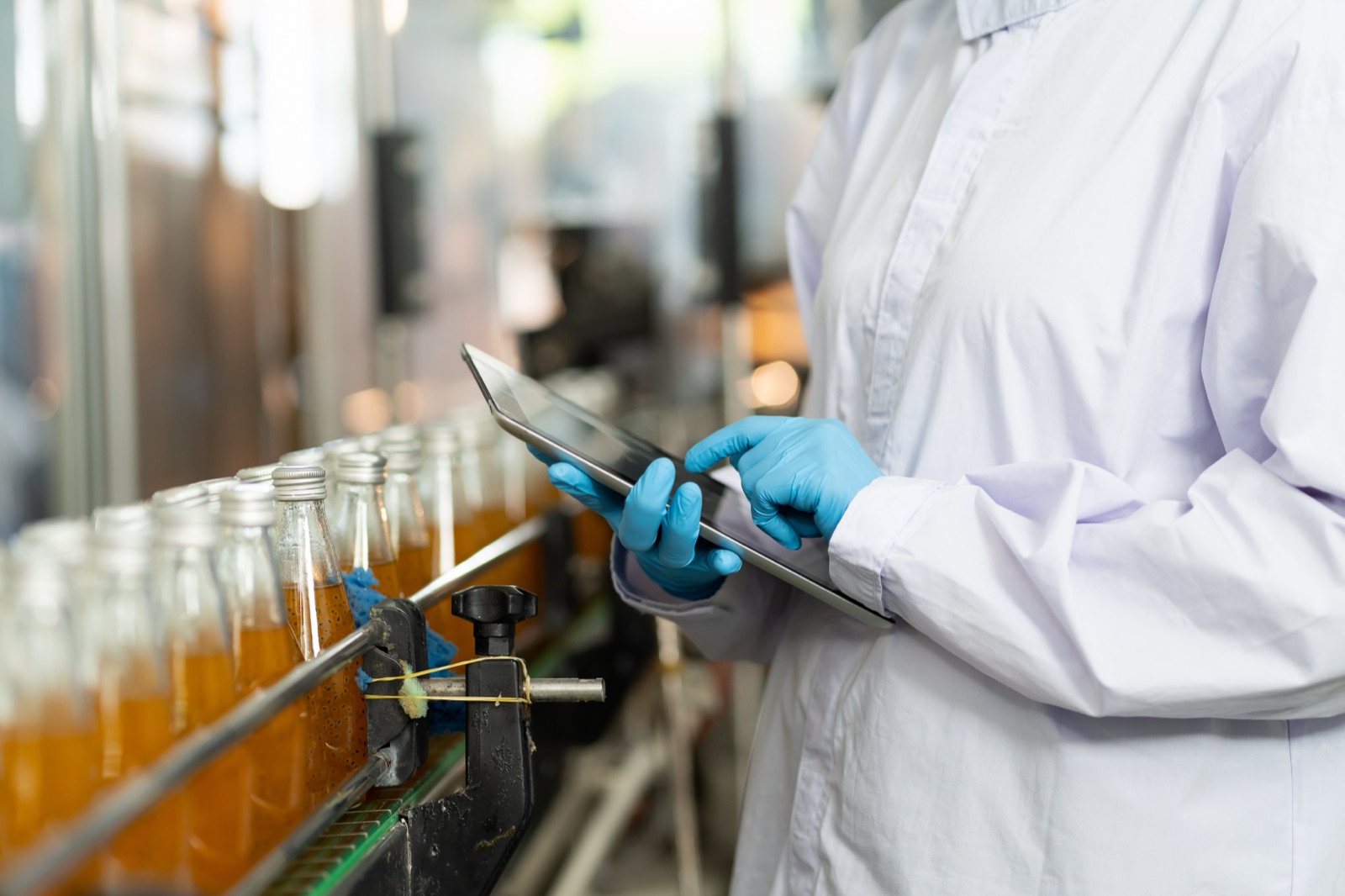 Technician monitoring a beverage line on a tablet during changeover
